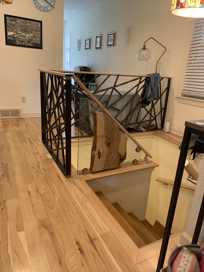 Hickory floors and custom railings to lower level - 1771 N Marshall St