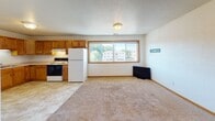 Located at 1311 Pohl Rd in Mankato, Minnesota, this single-floor unit offers a straightforward, functional layout designed for comfortable everyday living. The floor plan reveals a well-organized arrangement of rooms, with the kitchen and living area flowing together in an open configuration that maximizes usable space.

The kitchen is equipped with warm oak cabinetry providing ample upper and lower storage, light-toned countertops, a double stainless steel sink, and includes a refrigerator and electric range. Tile flooring runs throughout the kitchen, transitioning to carpet in the adjacent living area. A large window in the kitchen-living space draws in natural light and offers views of the surrounding neighborhood and mature trees.

The bedrooms are carpeted and feature neutral white walls, wood-trimmed windows that allow natural light to filter in, and wood baseboard trim throughout. At least one bedroom includes a closet with a built-in hanging rod. The bathrooms are clean and functional, each featuring a tub-shower combination, toilet, and a wood-trimmed vanity with tile flooring. Textured ceilings are consistent throughout the unit, contributing to its classic residential character. The overall ambiance is clean, neutral, and move-in ready.