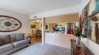 Located in Tucson, AZ, this 2-bedroom, 1-bathroom single-floor residence offers a thoughtfully arranged layout that maximizes its compact footprint. The open-concept living area features plush carpeting and a sliding glass door that fills the room with natural light while providing access to an outdoor patio with views of the surrounding landscape. Adjacent to the living room, the dining area showcases wood-look flooring, a tray ceiling detail, and a cozy atmosphere ideal for intimate meals. The kitchen is designed with efficiency in mind, featuring warm wood-toned cabinetry, stainless steel appliances including an electric range, over-the-range microwave, and refrigerator, all accessible via a convenient half-wall pass-through that connects seamlessly to the living and dining spaces. The primary bedroom offers comfortable carpeting, a window with outdoor views, and a closet, while the second bedroom also includes a closet and easy access to the shared hallway. The bathroom is finished with a wood-toned vanity, a wide mirror with overhead lighting, and wood-look flooring. A dedicated laundry area with a stacked washer and dryer unit adds everyday convenience. This well-appointed Tucson residence combines functional design with comfortable living throughout.