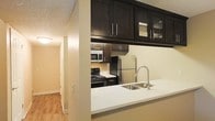 This single-floor residence offers a thoughtfully designed layout that balances functionality and modern style. The kitchen serves as a central highlight of the space, showcasing rich dark espresso cabinetry that extends to the upper walls, providing generous storage while creating a bold visual contrast against the light-toned walls and crisp white countertops. Upper cabinets feature glass-panel inserts, adding an elegant touch and allowing for decorative display. Stainless steel appliances — including a refrigerator, microwave, and gas range — lend a contemporary, professional feel to the cooking space. A peninsula counter with a deep double-basin sink and a modern arc faucet extends outward, creating a natural divide between the kitchen and the adjacent living area while offering convenient additional workspace or casual dining. Warm hardwood-style flooring flows throughout the hallway and living areas, contributing to a cohesive and inviting ambiance. The textured ceiling adds subtle architectural character, while recessed and flush-mount lighting ensures the space remains well-lit. The overall design is clean, modern, and practical, making this a comfortable and stylish single-floor living environment.