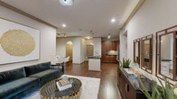 Located in Houston's vibrant Montrose neighborhood, this well-appointed 2-bedroom, 2-bathroom residence offers a thoughtfully designed single-level layout that balances style and functionality. The open-concept living area features rich hardwood flooring, crown molding with gold accents, and large windows with a glass-panel door that invite natural light and provide access to an outdoor patio. The kitchen is equipped with warm cherry wood cabinetry, dark granite countertops, stainless steel appliances, a tile backsplash, and a peninsula island with seating beneath stylish pendant lighting. The adjacent dining area showcases parquet hardwood flooring and ample wall space ideal for artwork. The primary bedroom includes plush carpet, a decorative feature wall, a ceiling fan, and a private en-suite bathroom with a dual-sink vanity, dark granite countertops, rich wood cabinetry, and a soaking tub. A walk-in closet with wire shelving provides generous storage. The second bedroom and bathroom offer equally refined finishes. A dedicated built-in office nook with a granite desk surface and overhead shelving adds a practical workspace. Two closets and a hallway complete the layout, making this residence a refined and functional home in the heart of Houston.