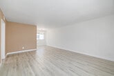 Located at 8722 Delgany Ave in the coastal neighborhood of Playa del Rey, Los Angeles, this 2-bedroom, 2-bathroom single-floor unit offers a clean, bright, and well-organized layout. Light wood-style flooring runs continuously throughout the space, complementing the crisp white walls and creating a cohesive, airy feel.

The open living room is generously proportioned, featuring a neutral two-tone color scheme with a warm taupe accent wall, a chandelier-lit dining area, and large windows that invite abundant natural light. The galley-style kitchen is efficiently designed with ample white cabinetry, light countertops, a stainless steel refrigerator, and a stainless steel range, making it highly functional.

The primary bedroom is a comfortable, well-sized retreat featuring dual mirror-door sliding closets and wide windows that brighten the room naturally. The second bedroom is equally bright with a window overlooking greenery and its own mirrored sliding closet. Both bathrooms are finished with white cabinetry, vanity mirrors, and light countertops; one includes a tub-shower combination with glass sliding doors, while the other features a walk-in shower configuration. A connecting hallway ties all rooms together in a practical, flowing floor plan.