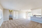 Located at 46745 Monroe St in Indio, CA, this single-story 1-bedroom, 1-bathroom unit offers a well-designed layout that maximizes its comfortable footprint. The open-concept living and dining area is finished with plush wall-to-wall carpeting and neutral-toned walls, creating a bright and airy atmosphere. A large sliding glass door fills the space with natural light and provides access to a private balcony. The kitchen is a standout feature, boasting white shaker-style cabinetry, gray stone countertops, wood-look flooring, recessed lighting, and a full suite of stainless steel appliances including a gas range, built-in microwave, dishwasher, and refrigerator. A peninsula counter seamlessly connects the kitchen to the dining and living areas. The spacious bedroom offers generous proportions, soft carpeting, and ample natural light, complemented by three closets throughout the unit for abundant storage. The full bathroom is well-appointed with white cabinetry, a granite-style countertop, wood-look flooring, and a tub/shower combination with a high window for natural light. A hallway and utility room round out the functional layout of this well-maintained Indio residence.