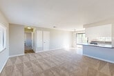 Located at 46745 Monroe St in Indio, CA, this single-story 1-bedroom, 1-bathroom unit offers a well-designed layout that maximizes its comfortable footprint. The open-concept living and dining area is finished with plush wall-to-wall carpeting and neutral-toned walls, creating a bright and airy atmosphere. A large sliding glass door fills the space with natural light and provides access to a private balcony. The kitchen is a standout feature, boasting white shaker-style cabinetry, gray stone countertops, wood-look flooring, recessed lighting, and a full suite of stainless steel appliances including a gas range, built-in microwave, dishwasher, and refrigerator. A peninsula counter seamlessly connects the kitchen to the dining and living areas. The spacious bedroom offers generous proportions, soft carpeting, and ample natural light, complemented by three closets throughout the unit for abundant storage. The full bathroom is well-appointed with white cabinetry, a granite-style countertop, wood-look flooring, and a tub/shower combination with a high window for natural light. A hallway and utility room round out the functional layout of this well-maintained Indio residence.