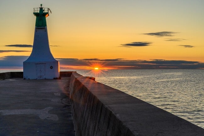 Burlington Canal pier lighthouse at sunset.