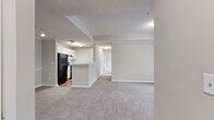 Located at 50 Greenleaf Rd in Conyers, GA, this single-floor, 2-bedroom, 1-bathroom home offers a functional and well-organized layout. The open-concept living and dining area flows seamlessly into the kitchen, which features white cabinetry, light-toned countertops, a peninsula with a sink, wood-look flooring, and black appliances including a full-size refrigerator and range. The spacious living room is carpeted and filled with natural light, with track lighting adding a practical touch. Both bedrooms are carpeted and generously sized, each with large windows that invite natural light and offer views of the surrounding greenery. The primary bedroom features a tray ceiling detail and a private door leading to the outdoors, along with a ceiling fan for year-round comfort. The second bedroom also benefits from a ceiling fan and a large window. The full bathroom includes a soaking tub with tile surround and wood-look flooring. A dedicated in-unit laundry room with full-size washer and dryer hookups adds everyday convenience. Two closets provide ample storage throughout. Neutral tones and clean finishes give the home a bright, move-in-ready feel.