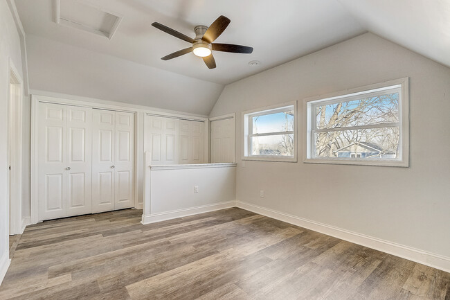 Back bedroom with plenty of storage and door leads to small deck overlooking backyard - 107 Dunning St