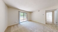 Located at 137 Brook Pines Dr in Columbia, SC, this 2-bedroom, 1-bathroom residence offers a practical and comfortable single-floor layout. The living room is bright and welcoming, featuring soft carpeted flooring, neutral beige walls, and a textured ceiling. A large sliding glass door floods the space with natural light and opens to a view of mature trees and a lush green outdoor setting, creating a calm, natural ambiance throughout.

The kitchen is efficiently designed with warm wood cabinetry, ample storage, a double sink with gray countertops, and tile flooring. White appliances, including a coil-top range with overhead hood and a full-size refrigerator, complete the functional cooking space.

Both bedrooms continue the carpeted flooring and neutral color palette, providing quiet, versatile spaces. The primary bedroom offers a comfortable footprint, while the second bedroom is equally practical.

The bathroom features tile flooring that complements the kitchen, a full tub-shower surround with built-in shelving, a white vanity, and brushed nickel fixtures, offering a clean, well-appointed finish.

Overall, the space presents a straightforward and functional layout with a consistent, neutral aesthetic, enhanced by its peaceful wooded surroundings in Columbia, South Carolina.