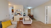 Located at 200 High Ridge Dr in Sanford, NC, this single-floor residence offers a practical and cohesive layout designed for comfortable everyday living. The living room serves as the central gathering space, featuring plush wall-to-wall carpeting, a textured ceiling, and large patio doors that allow natural light to fill the room. The open flow connects the living area to a dedicated dining space, making the floor plan feel connected and versatile. A pass-through window links the dining and living areas to the kitchen, which is outfitted with warm-toned wood cabinetry, light tile flooring, ample counter space, and a full suite of white appliances including a refrigerator, electric range, dishwasher, and additional storage. The bedroom is a well-proportioned retreat featuring soft carpeting, a closet, and windows dressed with draping curtains that provide both natural light and privacy. The bathroom is clean and straightforward, featuring a shower-tub combination with a decorative curtain and chrome fixtures. Throughout the home, neutral wall tones and consistent flooring choices create a unified, calm ambiance suited to a range of personal styles.
