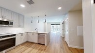 This contemporary 640 square foot apartment in Denver offers a blend of style and functionality. The open-concept design seamlessly integrates the living room and kitchen, creating a spacious feel. The kitchen boasts modern white cabinetry, stainless steel appliances, and a practical peninsula with a sink, perfect for meal prep or casual dining.

The bedroom, measuring 140 square feet, provides ample space and features a large window for natural light. A generously sized closet offers valuable storage. The bathroom showcases a sleek design with a marble-patterned tub surround and modern fixtures.

Throughout the apartment, warm wood-tone flooring adds a touch of warmth and elegance. Large windows in the living area and bedroom not only flood the space with natural light but also offer city views. A private balcony extends the living space outdoors.

Practical amenities include in-unit laundry with stacked washer and dryer, recessed lighting, and a ceiling fan in the bedroom. The apartment's thoughtful layout maximizes space efficiency, making it an ideal urban dwelling for those seeking a contemporary lifestyle in the heart of Denver.