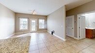 Located at 3455 Trail Head Dr in Paducah, KY, this single-floor, 2-bedroom, 2-bathroom home offers a functional and comfortable layout. The kitchen is a standout feature, showcasing warm wood cabinetry, granite countertops, a stone tile backsplash with a decorative diamond accent, and a full suite of stainless steel appliances including a refrigerator, range, microwave, and dishwasher. Large tile flooring runs throughout the kitchen and living areas, while a pendant chandelier and recessed lighting add warmth.

The living area is bright and open, benefiting from natural light streaming through multiple windows and glass French doors that lead to an outdoor space, complemented by a ceiling fan overhead. Both bedrooms feature plush carpeting, ceiling fans, and neutral-toned walls. The spacious primary bedroom connects to a dedicated bathroom and includes access to a walk-in closet outfitted with wire shelving systems for organized storage.

Both bathrooms are finished with tile flooring, wood-toned vanities with white countertops, and tub/shower combinations. Clean lines and neutral tones throughout the home create a cohesive, move-in-ready aesthetic well-suited for comfortable everyday living.