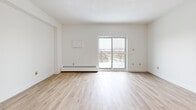 Located at 405 Park Rd N in Brantford, Ontario, this well-appointed 2-bedroom, 1-bathroom unit offers a practical and comfortable layout across a single floor. Light wood laminate flooring runs throughout the space, creating a bright and cohesive aesthetic.

The open-concept living and dining area is a standout feature, offering generous proportions and a sliding glass door that leads to a private balcony with scenic outdoor views. A chandelier adds a touch of warmth to the dining area, which connects to the kitchen via a pass-through window. The kitchen is equipped with warm wood cabinetry and ample storage, including a tall pantry-style cabinet.

The primary bedroom is a comfortable size and features a walk-in closet with wire shelving, providing excellent storage capacity. The second bedroom is bright and well-proportioned, with a sliding door closet and a window that brings in natural light. Both bedrooms are finished with the same light wood flooring found throughout the unit.

The bathroom includes a full tiled tub-shower combination, complemented by wood-toned flooring. Additional conveniences include a dedicated laundry area and multiple closets accessible from the hallway. The unit's clean, neutral palette and functional layout make it a practical and inviting living space.