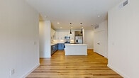 Located at 701 Saginaw Blvd in Saginaw, TX, this well-appointed 2-bedroom, 3-bathroom residence offers a thoughtfully designed single-floor layout with modern finishes throughout. Warm-toned luxury vinyl plank flooring flows seamlessly across the entire space, creating a cohesive and inviting atmosphere.

The heart of the home is an open-concept living, dining, and kitchen area filled with natural light. The kitchen is a standout, featuring two-tone cabinetry — white upper cabinets paired with slate-gray lowers — white quartz countertops, a central island with pendant lighting, and a full suite of stainless steel appliances including a refrigerator, range, microwave, and dishwasher.

The living area connects directly to a private patio, extending the living space outdoors. A ceiling fan and large windows enhance comfort and brightness throughout. The primary bedroom is generously sized with a ceiling fan, natural light, and access to a well-appointed en-suite bathroom featuring a gray floating vanity, white countertop, and a walk-in closet with built-in shelving. Two additional bathrooms and multiple closets provide ample storage. A dedicated laundry area and clean, light-filled hallways complete this polished, contemporary residence.