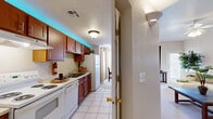 Located at 435 Ithaca Ct in Las Cruces, NM, this well-designed single-floor home offers a thoughtful layout across one bedroom and one bathroom. The kitchen is efficiently arranged with warm wood cabinetry, white appliances including a range, dishwasher, and refrigerator, complemented by light tile flooring and a window that brings in natural light. Adjacent to the kitchen, the dining area features a tray ceiling detail, a pendant light fixture, and a large window that fills the space with sunlight, creating an inviting atmosphere. A private exterior door in the dining area provides convenient outdoor access. The living room is generously proportioned with plush carpeting, elevated ceilings, a ceiling fan, and an arched architectural detail that adds character. Natural light filters in through multiple windows, enhancing the open and airy feel of the space. The primary bedroom is a comfortable retreat, also carpeted, with a ceiling fan and ample room for furnishings. The bathroom includes a full tub-shower combination with clean white tile surround. A dedicated closet and additional hallway storage round out the functional layout, making this home a practical and comfortable residence in Las Cruces.