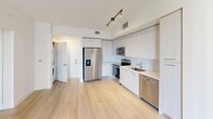This 660-square-foot single-story residence offers a blend of functionality and contemporary design. The home comprises three bedrooms, including a primary bedroom of 140 square feet, one bathroom, a kitchen, and additional spaces such as a closet and hallway. The interior is characterized by its bright, airy atmosphere, achieved through a predominantly white color scheme and ample natural light from windows.

The kitchen stands out with its sleek, modern design, featuring white cabinetry, stainless steel appliances, and a linear layout that maximizes efficiency in the compact space. The bathroom showcases a modern aesthetic with large-format tile work and a combination tub-shower unit.

Throughout the home, light-toned wood-look flooring creates a sense of warmth and continuity. Ceiling fans in the bedrooms provide both illumination and air circulation. The rooms, while modestly sized, feel spacious due to the minimalist design approach and clever use of space.

The property's open floor plan enhances the sense of space, with seamless transitions between living areas. Despite its compact footprint, the home offers practical living quarters with a contemporary flair, ideal for those seeking a low-maintenance lifestyle without compromising on modern amenities.