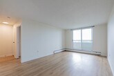 Located at 868 Dundas St in Woodstock, Ontario, this 2-bedroom, 1-bathroom unit offers a practical and well-organized single-floor layout. The living room is a standout space, featuring large sliding windows and an additional side window that fill the room with natural light and offer pleasant views of a landscaped green area. Durable laminate flooring runs throughout, providing a cohesive and easy-to-maintain finish across the unit. The kitchen is positioned conveniently off the main hallway, which also provides access to the dedicated closet and additional storage. Both bedrooms are bright and well-proportioned, finished with the same laminate flooring and neutral warm-toned walls. The primary bedroom offers a comfortable footprint, while the second bedroom features built-in sliding closet doors, maximizing storage efficiency. A hallway connects the bedrooms to the shared full bathroom, which is equipped with a soaking tub and tiled surround in a neutral beige palette with chrome fixtures. Textured ceilings are present throughout the unit, and the overall interior is finished in soft, neutral tones, creating a clean and move-in ready atmosphere.