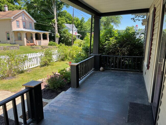 Front porch offers shady relaxing retreat - 61 Main St