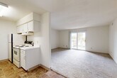 Located at 8819 Hickman Rd in Urbandale, Iowa, this two-bedroom, one-bathroom unit offers a practical and functional single-floor layout. The living room is bright and inviting, featuring plush carpeting, a textured ceiling, and a sliding glass door that opens to an outdoor deck, allowing natural light to fill the space and providing easy access to the outdoors. A ceiling fan adds comfort to the living area, which flows into the combined kitchen and dining space. The kitchen is equipped with white cabinetry, an electric range, and tile flooring that contrasts with the carpeted living areas.

Both bedrooms are carpeted and feature windows that bring in natural light with views of the surrounding landscape. The primary bedroom stands out with dual closets offering generous built-in shelving, alongside a door connecting directly to the full bathroom. The bathroom features tile flooring, a tiled tub surround with decorative accents, a wide vanity with a marble-style countertop, dark cabinetry, and a well-lit mirror. Additional storage is provided throughout the unit with a total of five closets. A dedicated utility room and a hallway complete the efficient floor plan, making this a well-organized and functional living space.