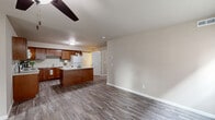 Located at 5265 Canyon Cir in Newburgh, Indiana, this single-floor, 2-bedroom, 1-bathroom home offers a well-planned layout designed for comfortable everyday living. Consistent vinyl plank flooring in a light grey wood finish runs throughout the entire home, lending a clean and cohesive aesthetic to every room.

The open-concept kitchen and living area forms the heart of the home. The kitchen is well-appointed with rich warm-toned wood cabinetry, white appliances including a range, microwave, and refrigerator, light countertops, and a central island that provides additional prep and dining space. The adjoining living room is bright and airy, featuring a ceiling fan, multiple windows that invite natural light, and direct access to the front entry.

The primary bedroom offers a comfortable footprint with a window overlooking the neighborhood, while the second bedroom similarly benefits from natural light through its large window. Both rooms feature the same consistent flooring found throughout the home. The full bathroom is neatly finished with warm wood cabinetry, a white countertop vanity, a large mirror, and well-lit overhead lighting.

A utility room provides added functionality, and the attached garage — equipped with an automatic opener — offers convenient parking and additional storage. The overall ambiance is clean, neutral, and move-in ready.
