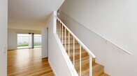Located at 3630 Midvale Ave in Los Angeles, this two-story unit offers a thoughtfully designed layout spread across two floors. Light-toned hardwood flooring runs throughout the space, creating a cohesive and bright aesthetic that complements the clean white walls found in every room.

The ground floor houses the main living area, which flows seamlessly into a well-appointed kitchen. The kitchen features white shaker cabinetry extending to the ceiling for ample storage, a white subway tile backsplash, light countertops, and a full suite of stainless steel appliances including a gas range, microwave, dishwasher, and refrigerator. Recessed lighting and a sliding glass door leading to a private patio with iron fencing complete this level.

Upstairs, two bedrooms offer comfortable accommodations. The primary bedroom includes mirrored sliding closet doors and a wall-mounted mini-split HVAC unit. The second bedroom features a wide window that brings in natural light. Both bathrooms are finished in a clean, minimal style—one includes a full tub-shower combination with white fixtures and a single vanity. A hallway connects the upper-floor rooms for practical circulation throughout.