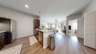 Located at 2025 N Broadmoor St in Wichita, KS, this thoughtfully designed 2-bedroom, 2-bathroom residence offers a comfortable and modern living experience on a single floor. The open-concept layout connects the kitchen, dining, and living areas seamlessly, creating an inviting and functional flow throughout the space.

The kitchen is a standout feature, showcasing rich dark espresso cabinetry, granite countertops, stainless steel appliances, and a peninsula with pendant lighting that doubles as a breakfast bar. Light wood-style flooring runs through the main living areas, adding warmth and continuity.

The spacious primary bedroom offers plush carpeting, a ceiling fan, natural light from large windows, and ample room to accommodate generous furniture arrangements. The second bedroom is equally comfortable, also carpeted and naturally lit. Each bedroom is served by its own closet for convenient storage.

Both bathrooms are finished with dark cabinetry, granite-topped vanities, and wood-style flooring, reflecting the cohesive design aesthetic carried throughout the home. The second bathroom features a tub-shower combination.

Neutral tones, recessed lighting, and clean architectural lines give the entire residence a bright and contemporary ambiance, making it a welcoming place to call home in east Wichita.