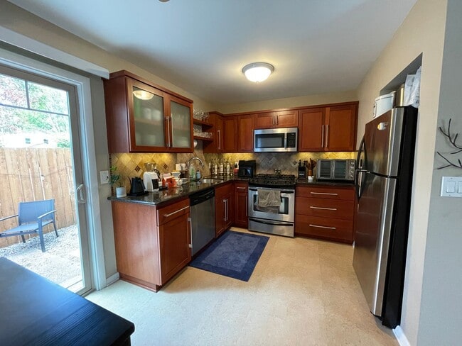 Building Photo - Stylish Corner Condo In Prime Location w/ Parking, Private Outdoor Space & W/D