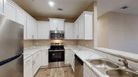 Located at 4750 Mac Rd in Valdosta, Georgia, this single-floor home offers a clean, modern interior with a cohesive neutral color palette and wood-look flooring carried consistently throughout. The kitchen is a standout feature, equipped with crisp white shaker-style cabinetry, marble-look countertops, and a full suite of stainless steel appliances including a range, over-the-range microwave, dishwasher, and refrigerator. A breakfast bar peninsula connects the kitchen to the open living area, creating a practical and inviting flow between spaces. The living area is generously sized, featuring a ceiling fan and a window that brings in natural light. The bedrooms continue the warm, neutral tones with wood-look flooring, ceiling fans, and windows fitted with white blinds that allow for natural light while maintaining privacy. One bedroom benefits from dual windows, filling the room with abundant daylight. The bathrooms feature white vanity cabinetry with marble-look countertops, mirrors, and a tub-shower combination. Hallways connect the rooms efficiently, with closet storage also accessible. The overall design is practical and move-in ready, presenting a well-maintained, uniformly finished interior suitable for comfortable everyday living.