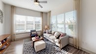 Located along the scenic shores of Lake Carolyn in Irving, Texas, this single-floor residence offers a thoughtfully designed layout with modern finishes throughout. The living room is a standout space, wrapped in expansive windows that flood the area with natural light and frame stunning waterfront views. Wood-look flooring, a ceiling fan, and generous proportions create a welcoming, airy atmosphere. The adjacent dining area continues the bright aesthetic, with large windows overlooking lush greenery and elegant drapery adding a refined touch. The kitchen is well-equipped with white shaker cabinetry, granite-style countertops, stainless steel appliances, a decorative tile backsplash, and ample storage — ideal for everyday cooking and entertaining. Two bedrooms provide comfortable retreats; the primary bedroom features plush carpeting, a ceiling fan, and natural light from well-dressed windows, while the second bedroom offers a similarly serene environment. The primary bathroom is appointed with a dual-sink vanity, wood-look tile flooring, and a sleek frameless glass walk-in shower. A second full bathroom includes a soaking tub and shower combination. Completing the unit is a dedicated in-unit laundry room with full-size washer and dryer, adding everyday convenience to this polished lakeside residence.