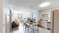 Located at 1717 N 12th St in Philadelphia, PA, this modern 2-bedroom, 4-bathroom unit offers a thoughtfully designed open-concept layout that maximizes both space and natural light. The combined kitchen and living area serves as the heart of the unit, featuring floor-to-ceiling windows that frame sweeping views of the Philadelphia skyline. The kitchen is appointed with light wood cabinetry, stainless steel appliances including a refrigerator, range, and dishwasher, and is complemented by a pantry for additional storage. A bar-height dining table provides a seamless transition between the kitchen and the bright, airy living room. Light hardwood flooring runs throughout the main living areas, enhancing the clean, contemporary aesthetic. Each bedroom features soaring ceilings with warm wood accents, carpeted flooring, and generous closet space. The primary bedroom benefits from expansive windows offering continued city views. Four well-appointed bathrooms serve the unit, ensuring ample convenience. The overall ambiance is modern and inviting, with a neutral palette, abundant natural light, and urban skyline views that make this Philadelphia residence a distinctive living space.