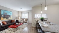 Located in the heart of Kansas City, this single-floor residence at 228 W 4th St offers a thoughtfully designed open-concept layout that seamlessly connects the kitchen, dining, and living areas. The kitchen is a standout feature, outfitted with dark espresso cabinetry, granite countertops, stainless steel appliances including a range, microwave, and refrigerator, and a peninsula breakfast bar with industrial-style metal seating — ideal for both casual dining and entertaining. Pendant lighting adds a modern touch overhead, while natural light pours in through multiple windows. The living area provides a comfortable and well-proportioned space with warm hardwood-style flooring, large windows dressed with patterned curtains, and ample room for relaxed seating arrangements. The bedroom features plush carpeting, a ceiling fan, generous closet space, and a calm, neutral palette. A second closeted bedroom or flex space offers additional versatility. The bathroom is clean and functional, featuring a granite-topped vanity with dark cabinetry, a full tub-shower combination, and hardwood-style flooring. Throughout the residence, a cohesive neutral color scheme, contemporary fixtures, and quality finishes create a polished and inviting atmosphere.