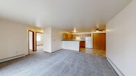 Located at 1660 W Evergreen Dr in Appleton, Wisconsin, this single-floor, 2-bedroom, 1-bathroom unit offers a practical and well-organized layout. The entrance opens into a spacious living room featuring plush carpet flooring, a baseboard heating system, and a sliding glass patio door that fills the space with natural light and provides outdoor access to a balcony with green views. A wall-mounted air conditioning unit ensures year-round comfort.

The kitchen flows directly from the living area and is equipped with oak cabinetry, dark countertops, a double-basin sink, a dishwasher, a range, and a full-size refrigerator. A ceiling fan with integrated lighting adds functionality. Tile flooring transitions naturally between the kitchen and living spaces.

The primary bedroom is a comfortable size, featuring plush carpet, a ceiling-mounted light fixture, a large window with outdoor views, and a mirrored sliding closet. The second bedroom also offers carpet flooring and baseboard heating, with built-in shelving providing additional storage. Both rooms are bright and neutrally finished.

The full bathroom includes a tub/shower combination, a toilet, and an oak vanity with a dark countertop, backlit mirror, and tile flooring consistent with the rest of the wet areas. Throughout the unit, warm wood trim and neutral walls create a clean, functional living environment.