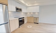 This contemporary 480 square foot apartment in Richmond offers a thoughtfully designed living space. The single bedroom, measuring 100 square feet, provides a cozy retreat. The bathroom showcases a modern aesthetic with a floating vanity, large mirror, and clean lines. The kitchen is a highlight, featuring two-tone cabinetry in light wood and white, complemented by stainless steel appliances and ample counter space. The open-concept living area is enhanced by large windows that flood the space with natural light and offer urban views. Light-colored hardwood flooring runs throughout, creating a sense of continuity and spaciousness. Built-in closets in the bedroom provide essential storage. The apartment's neutral color palette and minimalist design create a blank canvas for personal style. Despite its compact size, the layout maximizes functionality, making it an ideal choice for those seeking an efficient urban living space.