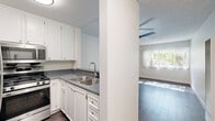 Located at 6235 Beck Ave in North Hollywood, Los Angeles, this one-bedroom, one-bathroom unit offers a practical and comfortable layout across a single floor. The kitchen features white cabinetry, dark countertops, a stainless steel sink, and an adjacent range, opening toward the living area through a partial wall divider. The living room is bright and airy, with dark wood-style flooring, a ceiling fan, a textured ceiling, and a large window that invites generous natural light and views of surrounding greenery. A wall-mounted A/C unit provides climate control. The bedroom is carpeted and comfortably sized, featuring a ceiling fan and a mirrored sliding-door closet that adds depth and reflects light throughout the room. Two additional closets offer ample storage throughout the unit. The bathroom is clean and functional, featuring a white vanity with a speckled countertop, a combined tub and shower with chrome fixtures, and wood-style flooring. Neutral tones and clean finishes throughout the unit create a bright, cohesive ambiance well-suited for comfortable everyday living.