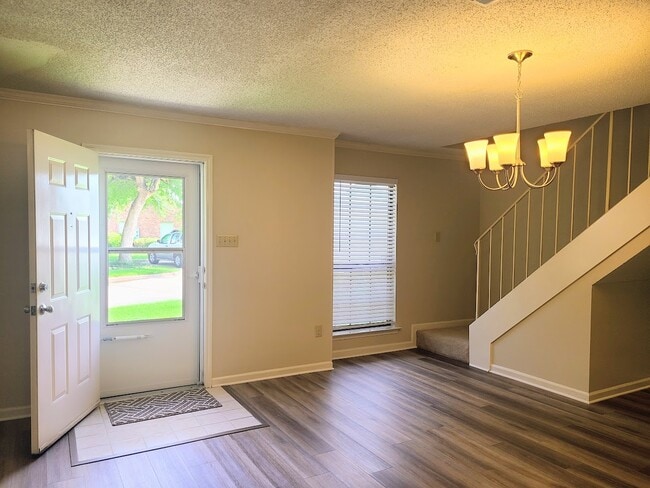 Front entrance with view of dining room and stairs to master bedroom - 12439 Coursey Blvd