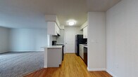 Located at 400 N Pebble Creek Terrace in Mustang, Oklahoma, this single-story unit presents a clean, functional layout with a neutral color palette throughout. The kitchen serves as a central feature, equipped with white cabinetry, a tiled backsplash, black appliances including a refrigerator, electric range, and dishwasher, and a peninsula counter that opens toward the living area. Durable hardwood-style flooring runs through the kitchen, providing a warm contrast to the bright white cabinetry and walls.

The living area is generously proportioned, finished with plush carpeting and neutral tones. A sliding glass door with vertical blinds allows natural light to fill the space while providing outdoor access. The carpeting continues into the bedroom, which features a wide window fitted with horizontal blinds, offering natural light and exterior views.

The bathroom includes a full tub and shower combination with a curved curtain rod, a vanity with white cabinetry and an integrated mirror, and warm-toned tile flooring. The overall design of the unit emphasizes a clean, move-in-ready aesthetic with consistent finishes, ample storage, and a practical, well-connected floor plan.