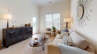 Located at 95 Salmon Brook St in Granby, Connecticut, this thoughtfully designed single-floor residence offers a seamless blend of comfort and modern style. The spacious living room features soaring ceilings accented by elegant crown molding, soft neutral carpeting, and generous natural light streaming through large windows that look out onto an outdoor balcony area. The open-concept kitchen is outfitted with crisp white shaker cabinetry, granite countertops, stainless steel appliances including a French door refrigerator and electric range, and warm hardwood-style flooring. A peninsula with bar seating connects the kitchen to a casual dining area, making it ideal for both everyday living and entertaining. The residence includes multiple well-proportioned bedrooms, each featuring plush carpeting and ample closet space. One bedroom offers direct access to a private balcony through sliding glass doors, flooding the room with natural light. The primary bathroom is appointed with a white vanity, walk-in glass-door shower, and wood-look tile flooring, while a second full bathroom mirrors the clean, contemporary aesthetic with a shower/tub combination. Throughout, the warm, neutral color palette and quality finishes create a cohesive and inviting atmosphere.