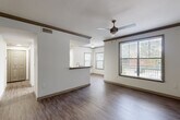 Located at 2000 Monroe Dr NE in Atlanta's Piedmont Heights neighborhood, this one-bedroom, one-bathroom unit offers a thoughtfully designed, single-floor layout with a comfortable sense of space throughout. The open-concept living area features rich hardwood-style flooring, crown molding with warm wood-tone accents, and a ceiling fan. Multiple windows fitted with blinds allow generous natural light and offer outdoor views, creating a bright and airy atmosphere. The kitchen is well-equipped with white cabinetry, granite countertops, stainless steel appliances including a refrigerator and range, and a convenient pass-through that connects seamlessly to the living area. The bedroom is carpeted for comfort, includes its own window with outdoor views, and is accessible via a six-panel door. The bathroom features a granite-topped vanity with white cabinetry, hardwood-style flooring, and a full shower-tub combination with tiled surround. A dedicated laundry room houses a full-size washer and dryer with overhead shelving for additional storage. A separate closet provides further storage solutions. The unit also includes a hallway that ties together the well-organized floor plan, making this an efficient and comfortable home in a prime Atlanta location.