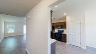 Located at 530 Acorn Ln in Statesboro, GA, this single-story home offers a practical and comfortable layout across two bedrooms and three bathrooms. Light-toned luxury vinyl plank flooring runs throughout the home, lending a clean, cohesive look to every room.

The kitchen features rich dark wood cabinetry, white countertops, and a full suite of black appliances including a refrigerator, electric range, and built-in microwave. A peninsula with additional cabinetry provides extra prep space and flows naturally into the adjacent living room, which benefits from vaulted ceilings, a large window, and a sliding glass door that fills the space with natural light.

Both bedrooms are generously proportioned with natural light from windows and access to well-organized closets fitted with wire shelving systems. The primary bedroom includes its own dedicated closet space. The three bathrooms are clean and functional, with at least one full bathroom featuring a tub-shower combination, wood-toned vanity, and hard flooring.

A dedicated laundry room includes washer/dryer hookups and overhead wire shelving for added utility. Six closets throughout the home provide exceptional storage capacity, complemented by a pantry off the kitchen. The attached garage offers a spacious, enclosed parking area with an automatic opener.
