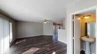 This two-story residence in Houston, TX features a thoughtfully designed layout with 2 bedrooms and 2.5 bathrooms. The main living area is generously sized, showcasing rich dark hardwood-style flooring, neutral gray walls, and a ceiling fan that adds both style and comfort. The space flows seamlessly into a dining area accented by a pendant light fixture, with vertical blinds allowing natural light to filter through.

The kitchen is well-appointed with crisp white shaker-style cabinetry, granite-look countertops, a double stainless steel sink, and stainless steel appliances, offering ample storage and prep space.

Upstairs, both bedrooms are carpeted and feature ceiling fans. One bedroom includes access to a private balcony with outdoor views, adding a welcoming touch of natural light. A spacious walk-in closet with built-in shelving and hanging rods provides generous storage.

The bathrooms are finished with granite-look countertops, white cabinetry, and updated fixtures. One full bath includes a soaking tub and shower combo with dark hardwood-style flooring, while another features a vanity with a well-lit mirror and medicine cabinet. A half bath completes the layout. The overall ambiance is clean, neutral, and move-in ready.