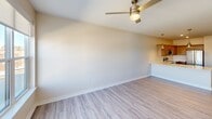 This contemporary 830 square foot apartment offers a thoughtfully designed living space in the heart of Cedar Rapids. The open-concept layout seamlessly blends the kitchen and living areas, creating an airy and spacious feel. The kitchen is a highlight, boasting modern taupe cabinetry, sleek stainless steel appliances, and ample counter space with white surfaces.

The bedroom, measuring 130 square feet, features plush carpeting and large windows that flood the space with natural light while offering city views. A ceiling fan adds both style and functionality. The bathroom is well-appointed with a vanity, mirror, and a combination shower/tub.

Convenience is key with an in-unit laundry area, complete with full-sized washer and dryer. The apartment showcases durable wood-look flooring throughout the main living areas, enhancing the modern aesthetic. Recessed lighting and additional ceiling fans contribute to the overall ambiance.

Storage solutions are plentiful, with closet space in the bedroom and laundry area. The neutral color palette provides a blank canvas for personal decorating styles. Located at 900 3rd St SE in Cedar Rapids, this apartment combines urban living with contemporary comforts in a single-floor layout.