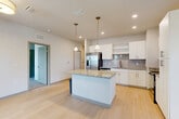 Located at 101 Zora Place in Lockhart, FL, this well-designed single-story home offers three bedrooms, two bathrooms, a den, and a dedicated laundry room across a thoughtfully laid-out floor plan. The open-concept kitchen and living area serves as the heart of the home, featuring crisp white cabinetry, granite countertops, a central island with pendant lighting, stainless steel appliances including a French-door refrigerator, and light wood-style flooring that extends throughout the main living spaces. Recessed lighting and natural light from multiple windows create a bright, airy atmosphere throughout. The living area includes a ceiling fan and a sliding glass-paned door that adds a contemporary touch while maintaining an open feel. The bedrooms are carpeted for comfort, each offering a clean, neutral palette and ample closet access — the home includes an impressive seven closets total. The primary bedroom provides a generous footprint with ceiling fan. Both bathrooms are finished with granite-top vanities, white cabinetry, and light tile flooring; one features a tub/shower combination. A dedicated laundry room houses a full-size washer and dryer with overhead shelving. The entrance and hallway connect all areas seamlessly, making this home both functional and inviting.