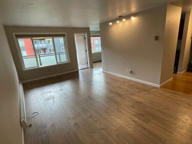 Spacious Living Room , balcony and eating area (seen beyond) - 7001 Sand Point Way NE