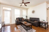 Located at 2741 Faudree Rd in Odessa, Texas, this single-floor residence offers a well-designed, open-concept layout that seamlessly connects the living, dining, and kitchen areas. Rich hardwood flooring runs throughout the main living spaces, complemented by crown molding and ceiling fans that add a polished finish.

The living room is bright and welcoming, featuring large windows with blinds that allow ample natural light, a front entry door with sidelights, and a ceiling fan overhead. The dining area sits adjacent to the living room beneath a track lighting fixture, offering an ideal space for everyday meals.

The kitchen is a standout feature, outfitted with dark espresso cabinetry, granite countertops, a peninsula with a double sink, and a full suite of stainless steel appliances including a refrigerator, electric range, and built-in microwave. A pendant light and track lighting illuminate the space effectively.

The bedrooms are carpeted and cozy, each equipped with a ceiling fan and window with blinds for natural light and ventilation. The two bathrooms mirror the kitchen's aesthetic with dark cabinetry and granite countertops. One bathroom features a glass-enclosed shower, while the other includes a shower-tub combination, both finished with tile flooring and large vanity mirrors.