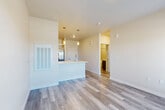 Located at 6415 Templeton Gap Road in Colorado Springs, CO, this one-bedroom, one-bathroom unit offers a well-designed, single-level layout that maximizes functionality and comfort. The open-concept living and kitchen area serves as the heart of the home, featuring light-toned luxury vinyl plank flooring that flows seamlessly throughout. The kitchen is equipped with stainless steel appliances — including a side-by-side refrigerator, range, over-the-range microwave, and dishwasher — complemented by gray shaker-style cabinetry and a clean white countertop. A peninsula with pendant lighting provides additional prep space and separates the kitchen from the living area. The living space opens to a private balcony through a glass door, allowing natural light to fill the room with outdoor views. The bedroom features plush carpeting, a bright window with exterior views, and neutral wall tones that create a calm, restful atmosphere. The walk-in closet offers generous storage with built-in shelving and hanging rods. The full bathroom is finished with gray cabinetry, a white countertop vanity, tile-surround soaking tub, and wood-look flooring, lending a clean, contemporary aesthetic throughout.