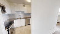 Located on the 15th floor at 1340 Danforth Rd in Toronto's Scarborough district, this well-appointed 2-bedroom, 2-bathroom unit offers a comfortable and functional layout across a generous single-floor footprint. The open kitchen is fitted with white cabinetry, a subway tile backsplash, light tile flooring, and a full suite of stainless steel appliances including a refrigerator, stove, and built-in microwave. It connects seamlessly to the living area, which features classic parquet hardwood flooring and large floor-to-ceiling windows that frame sweeping panoramic views of the Toronto cityscape and surrounding greenery. A sliding glass door provides access to a balcony, further enhancing the elevated outlook. The spacious primary bedroom benefits from its own impressive wall of windows, filling the room with natural light and offering the same stunning views. The second bedroom also features parquet flooring and a bright window. Both bathrooms are finished with clean white subway tile surrounds — one with a walk-in shower and the other with a full soaking tub and shower combination — each accented with chrome fixtures. A hallway connects all rooms efficiently, completing this bright, high-rise residence.