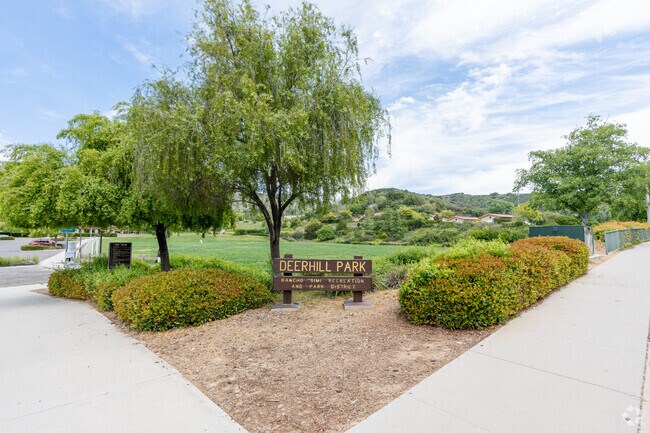 Deerhill Park sign and view of walking paths.
