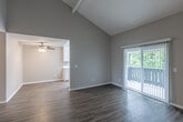 Located at 3401 South Plaza Drive in Santa Ana, CA, this well-appointed 2-bedroom, 2-bathroom residence offers a thoughtful layout across a single floor. The living room immediately impresses with its dramatic vaulted ceilings and rich hardwood-style flooring, creating an open, airy atmosphere. A sliding glass door with vertical blinds leads to a private balcony, filling the space with natural light and greenery views. The kitchen is designed for functionality, featuring a galley-style layout with crisp white cabinetry, light countertops, a stainless steel sink, a gas range, dishwasher, and a window that brings in additional natural light. A ceiling fan adds comfort to the adjacent dining area. The spacious primary bedroom is appointed with plush carpeting, a full mirrored sliding closet, and a dedicated en-suite bathroom featuring a walk-in shower. The second bedroom also features soft carpeting and a window with a view of surrounding greenery. A second full bathroom includes a tub-shower combination with chrome fixtures. Neutral tones throughout lend a clean, move-in-ready quality to the entire space, making it a practical and comfortable home in Southern California.