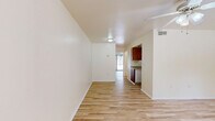 Located at 422 SW 69th St in Gainesville, FL, this single-floor, one-bedroom, one-bathroom unit offers a practical and well-organized layout. Light wood-look flooring flows consistently throughout the space, creating a clean, cohesive aesthetic. Ceiling fans are present in the main living areas, providing both comfort and light.

The living room is an open, neutral-toned space with a paneled entry door and a window that invites natural light. It connects seamlessly to the rest of the unit, maintaining an open feel throughout. The kitchen features warm wood cabinetry, a double-basin stainless steel sink with a light granite-style countertop, a full-size refrigerator, and a range — all set against light walls and matching flooring.

The bedroom is a well-proportioned room equipped with a ceiling fan, a built-in closet with bifold doors, and a window with blinds that allows natural light while maintaining privacy. The bathroom includes a full tub-shower combination with white subway tile surround, a toilet, and matching light flooring. Additional utility is provided by a dedicated closet and in-unit laundry area, making this a fully functional and self-contained home.
