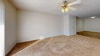 Located in West Lafayette, Indiana, this single-floor, 3-bedroom, 4-bathroom residence offers a well-organized and functional layout. The open-concept kitchen and dining area serves as the heart of the home, featuring white shaker-style cabinetry, granite countertops, a double stainless steel sink, and white appliances including a range and refrigerator. A peninsula counter provides additional workspace and naturally separates the kitchen from the adjoining living area, which is finished with warm wood-style flooring throughout. The living room is generously sized and filled with natural light, complemented by a ceiling fan for added comfort. Each of the three bedrooms is carpeted and includes dedicated closet space, with several rooms featuring walk-in closets equipped with wire shelving systems. The primary bedroom is a comfortable size with its own ceiling fan and ample storage. The four bathrooms are clean and efficiently designed, featuring wood-style flooring, bathtub-shower combinations, and towel bars. Additional highlights include a dedicated laundry area, a pantry, and a hallway connecting the home's spaces. Textured ceilings are consistent throughout, contributing to the home's cohesive, move-in-ready aesthetic.