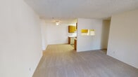 Located at 1035 Aster Ave in Sunnyvale, California, this single-floor residence offers a practical and well-organized layout. The open living area is finished with neutral wall-to-wall carpeting and features a textured ceiling with a ceiling fan, creating a comfortable, functional space. A pass-through window connects the living area to the kitchen, enhancing the sense of openness between rooms. The galley-style kitchen is equipped with warm wood-toned cabinetry, white countertops, a refrigerator, and a dishwasher, with light wood-style flooring underfoot and access to an additional utility or storage area. The bedrooms are carpeted and bright, each featuring textured ceilings, neutral walls, and windows that allow natural light to filter in; one bedroom includes a sliding glass door opening to a private balcony with outdoor views, while another is served by a baseboard heater. The bathroom features light wood-style flooring, a wood-vanity with a white countertop, mirrored medicine cabinets, and a separate water closet with a soaking tub and overhead shower. Throughout the residence, the clean, light color palette and straightforward design create a calm, move-in ready environment well-suited to everyday living in the heart of Sunnyvale.